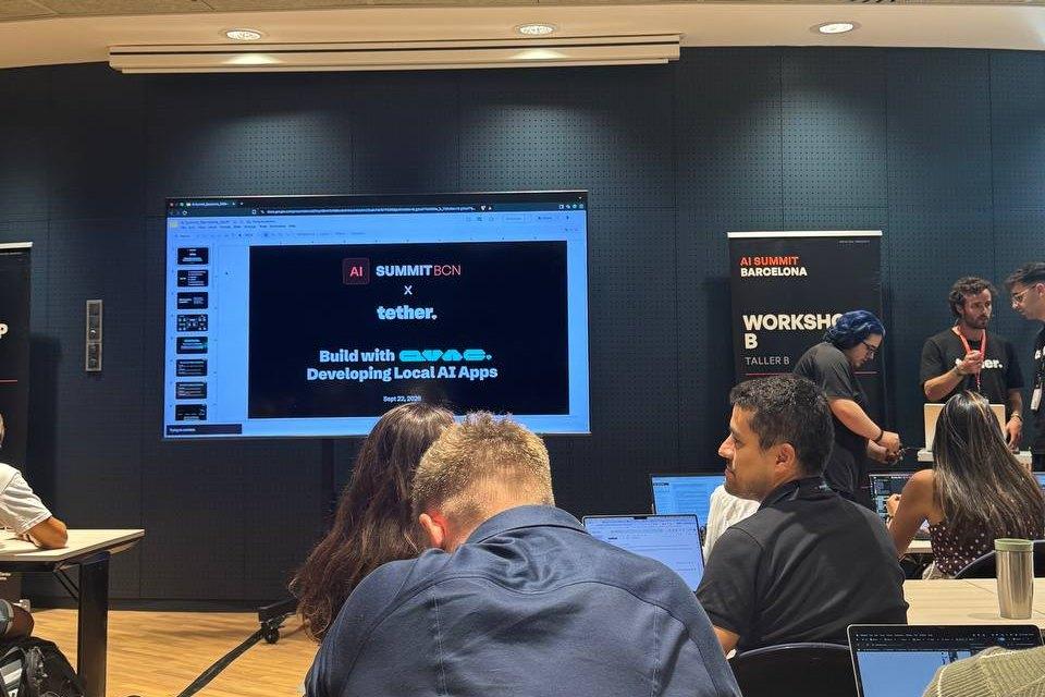 Workshop room at AI Summit Barcelona with a screen reading “AI Summit BCN × Tether — Build with QVAC: Developing Local AI Apps, Sept 22, 2026”